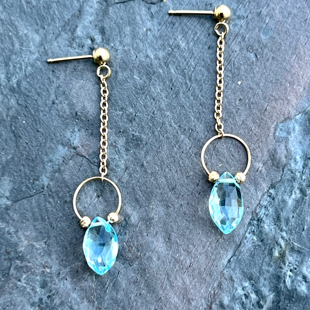 Blue topaz gemstone earrings in 14K gold by Garden of Silver in Westhampton Beach. www.gardenofsilver.com