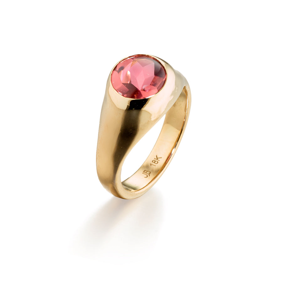 Crafted by renowned jewelry designer Jane Bartel, this 18k gold domed signet ring boasts a stunning 1.95 ct buff cut pink tourmaline. Elevate any look with this elegant and luxurious statement piece. www.gardenofsilver.com