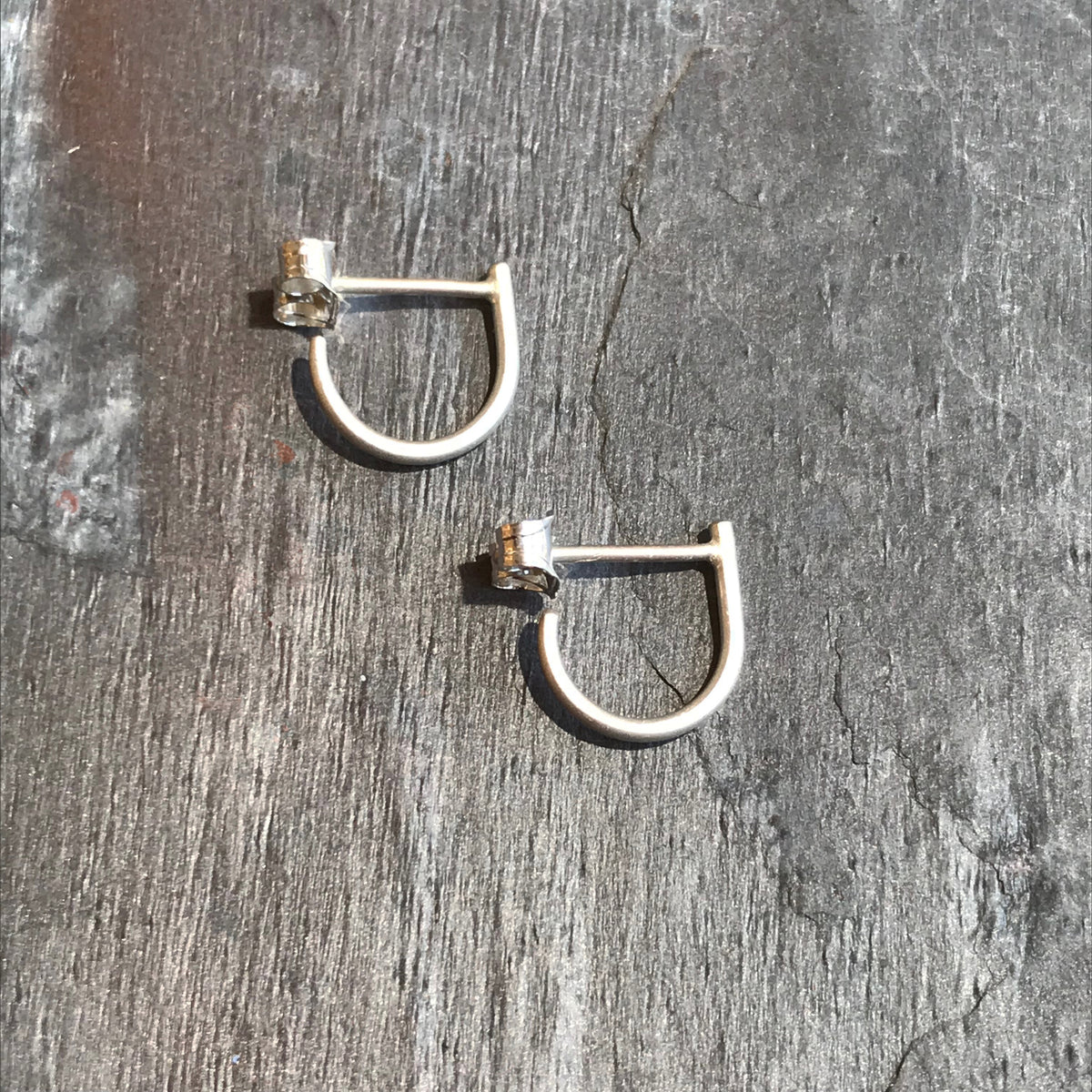 Small Silver Hugs earrings by Colleen Mauer at Garden of Silver in Westhampton Beach, New York.